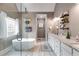 A neutral bathroom featuring a soaking tub and dual vanities is equipped with all you need to relax after a long day at 7511 Biltmore Ln, Douglasville, GA 30135