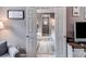 An ensuite bathroom is visible through a set of open doors, featuring dual vanities, a soaking tub, and wood look floors at 7511 Biltmore Ln, Douglasville, GA 30135