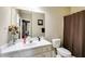 Neutral bathroom offers a large vanity with a white sink, and a shower and tub combination at 7511 Biltmore Ln, Douglasville, GA 30135
