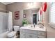 Neutral bathroom features a vanity with white marble countertop and undermount sink with red Coca-Cola decor at 7511 Biltmore Ln, Douglasville, GA 30135