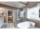 This bathroom features a glass enclosed shower, soaking tub and beautiful window that offers plenty of natural light at 7511 Biltmore Ln, Douglasville, GA 30135
