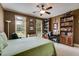 Bedroom featuring a ceiling fan, two windows, and desk area at 7511 Biltmore Ln, Douglasville, GA 30135