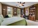 Bedroom features a large bed, bookshelves, and desk area, perfect for relaxation and productivity at 7511 Biltmore Ln, Douglasville, GA 30135