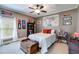 Cozy bedroom featuring a ceiling fan, neutral paint, and window with natural light at 7511 Biltmore Ln, Douglasville, GA 30135