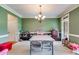 Spacious dining room featuring a chandelier, neutral carpet, and light green paint at 7511 Biltmore Ln, Douglasville, GA 30135