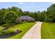 Beautiful single-story brick home with a well-manicured lawn and a long driveway at 7511 Biltmore Ln, Douglasville, GA 30135
