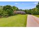 Well maintained front yard with manicured lawn and mature trees surround this home at 7511 Biltmore Ln, Douglasville, GA 30135
