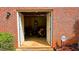 Open brick garage with double doors reveals a lawn mower and storage items inside, secured by BellSouth Security at 7511 Biltmore Ln, Douglasville, GA 30135