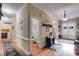 Hallway featuring wood floors, white trim, with views into a powder room and foyer at 7511 Biltmore Ln, Douglasville, GA 30135