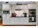 Clean white kitchen with stainless steel appliances and decorative touches at 7511 Biltmore Ln, Douglasville, GA 30135
