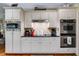 Modern kitchen with white cabinets, stainless steel appliances and black countertop at 7511 Biltmore Ln, Douglasville, GA 30135