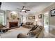 Inviting living room featuring a fireplace, ceiling fan, and comfortable sofas at 7511 Biltmore Ln, Douglasville, GA 30135
