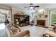 Comfortable living room with fireplace, built-in shelving, and large windows allowing for ample natural light at 7511 Biltmore Ln, Douglasville, GA 30135