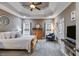 This carpeted primary bedroom features a trey ceiling and ample natural light at 7511 Biltmore Ln, Douglasville, GA 30135