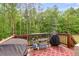 Outdoor deck features a grill, tables, and a decorative rug, perfect for outdoor entertainment at 7511 Biltmore Ln, Douglasville, GA 30135