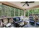 Comfortable screened-in porch with outdoor seating offers a relaxing space with a view of the lush yard at 7511 Biltmore Ln, Douglasville, GA 30135