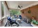 Relaxing screened porch boasts brick accent wall, ceiling fan, and comfortable seating for outdoor enjoyment at 7511 Biltmore Ln, Douglasville, GA 30135