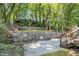 View of the backyard with a terraced retaining wall and wooden stairs at 802 Chestnut Nw, Atlanta, GA 30314