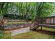 Picturesque backyard view with stone retaining wall, manicured landscaping, and deck with stairway at 802 Chestnut Nw, Atlanta, GA 30314