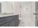 Bathroom with a gray vanity and a tiled shower and tub at 802 Chestnut Nw, Atlanta, GA 30314