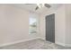 Bedroom featuring carpet, a ceiling fan, a window, and a gray door at 802 Chestnut Nw, Atlanta, GA 30314
