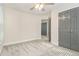 Bedroom featuring carpet, a ceiling fan, a window, and a gray door at 802 Chestnut Nw, Atlanta, GA 30314