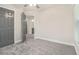 Bedroom featuring carpet, a ceiling fan, a window, and a gray door at 802 Chestnut Nw, Atlanta, GA 30314