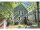 View of the two story, green house with stairs to the front door at 802 Chestnut Nw, Atlanta, GA 30314
