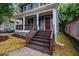 Inviting front porch with wooden stairs and fresh landscaping at 802 Chestnut Nw, Atlanta, GA 30314