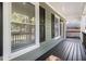 Covered front porch featuring black wood floors and white columns at 802 Chestnut Nw, Atlanta, GA 30314