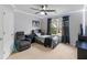 Cozy bedroom featuring carpeted floor, ceiling fan and a bright window view at 973 Buckhorn Bnd, Locust Grove, GA 30248