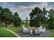Outdoor fire pit with Adirondack chairs overlooking the lake at 973 Buckhorn Bnd, Locust Grove, GA 30248