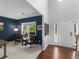 Cozy living room features a chair set, hardwood floors, and ample natural light at 973 Buckhorn Bnd, Locust Grove, GA 30248