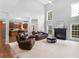 Bright living room boasts high ceilings, fireplace, and open layout to the kitchen at 973 Buckhorn Bnd, Locust Grove, GA 30248