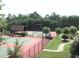 View of the community tennis courts surrounded by trees at 973 Buckhorn Bnd, Locust Grove, GA 30248