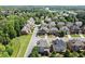An aerial view of a residential neighborhood showing various homes, tree-lined streets, and manicured lawns at 11240 Avery Cove Ct, Alpharetta, GA 30022