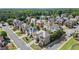 An aerial view of a neighborhood showcasing well-maintained homes, tree-lined streets, and community spaces at 11240 Avery Cove Ct, Alpharetta, GA 30022