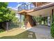 A backyard featuring a covered patio, upper level deck, fenced yard, and lush greenery at 11240 Avery Cove Ct, Alpharetta, GA 30022