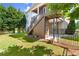 Landscaped backyard showcasing a multi-tiered deck, fenced yard, and mature trees, ideal for entertaining at 11240 Avery Cove Ct, Alpharetta, GA 30022