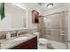 Bathroom features a granite countertop vanity and a glass-enclosed shower with tile surround at 11240 Avery Cove Ct, Alpharetta, GA 30022