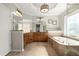 Bright bathroom featuring a large tub, tiled walls, and a vanity at 11240 Avery Cove Ct, Alpharetta, GA 30022
