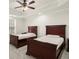 Comfortable bedroom with two beds, ceiling fan, neutral walls, and ample natural light from a large window at 11240 Avery Cove Ct, Alpharetta, GA 30022
