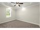 Neutral bedroom with a fan, large window and plush carpet provides a blank canvas for personalization at 11240 Avery Cove Ct, Alpharetta, GA 30022
