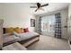 This bedroom has stylish decor, plush carpet, and large windows that provide plenty of natural light at 11240 Avery Cove Ct, Alpharetta, GA 30022