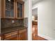Butler's pantry with granite counters, cabinets, and access to the kitchen, perfect for entertaining at 11240 Avery Cove Ct, Alpharetta, GA 30022