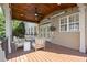 Cozy covered deck boasts a wood ceiling, outdoor lighting, and comfortable seating for relaxation and entertainment at 11240 Avery Cove Ct, Alpharetta, GA 30022