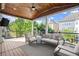 Covered deck with wood ceiling, ceiling fan, outdoor furniture, and a view of the backyard at 11240 Avery Cove Ct, Alpharetta, GA 30022
