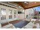 Inviting covered patio featuring a wood ceiling, outdoor TV, and comfortable seating area at 11240 Avery Cove Ct, Alpharetta, GA 30022