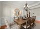 Elegant dining room with chandelier lighting, tray ceilings, and ample seating for eight at 11240 Avery Cove Ct, Alpharetta, GA 30022