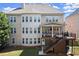 Back of home view of multi-story home featuring a deck, large windows, and a well-maintained lawn at 11240 Avery Cove Ct, Alpharetta, GA 30022